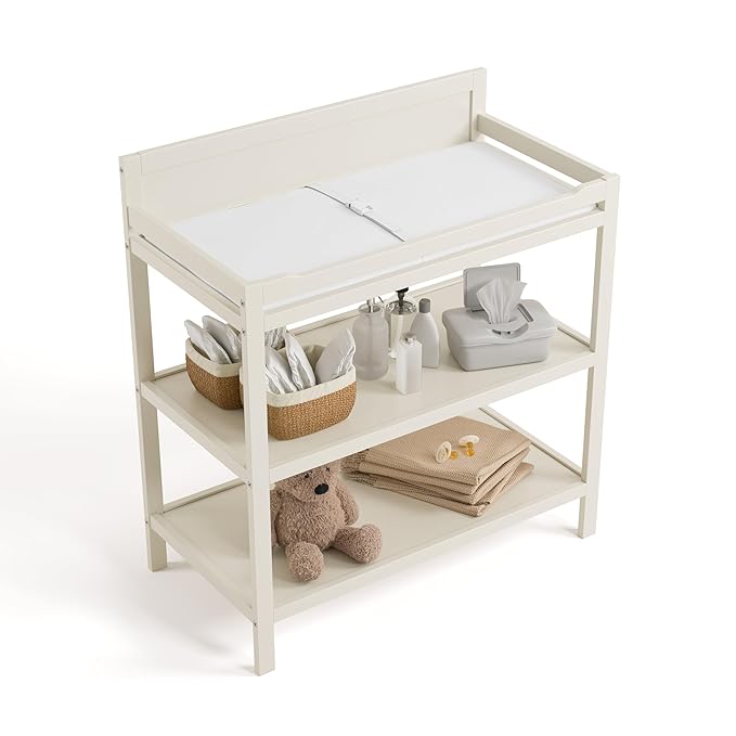 Storkcraft Alpine Changing Table (Frosted Oat) - Includes Water Resistant Changing Pad with Safety Strap, 2 Open Shelves for Storage